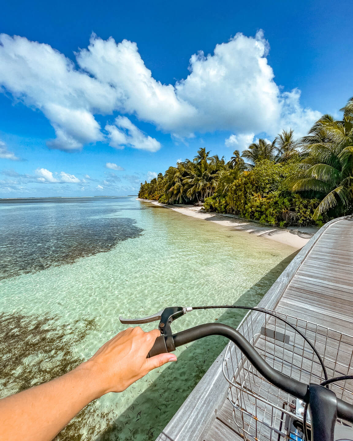 bike riding in Maldives on wooden jetty